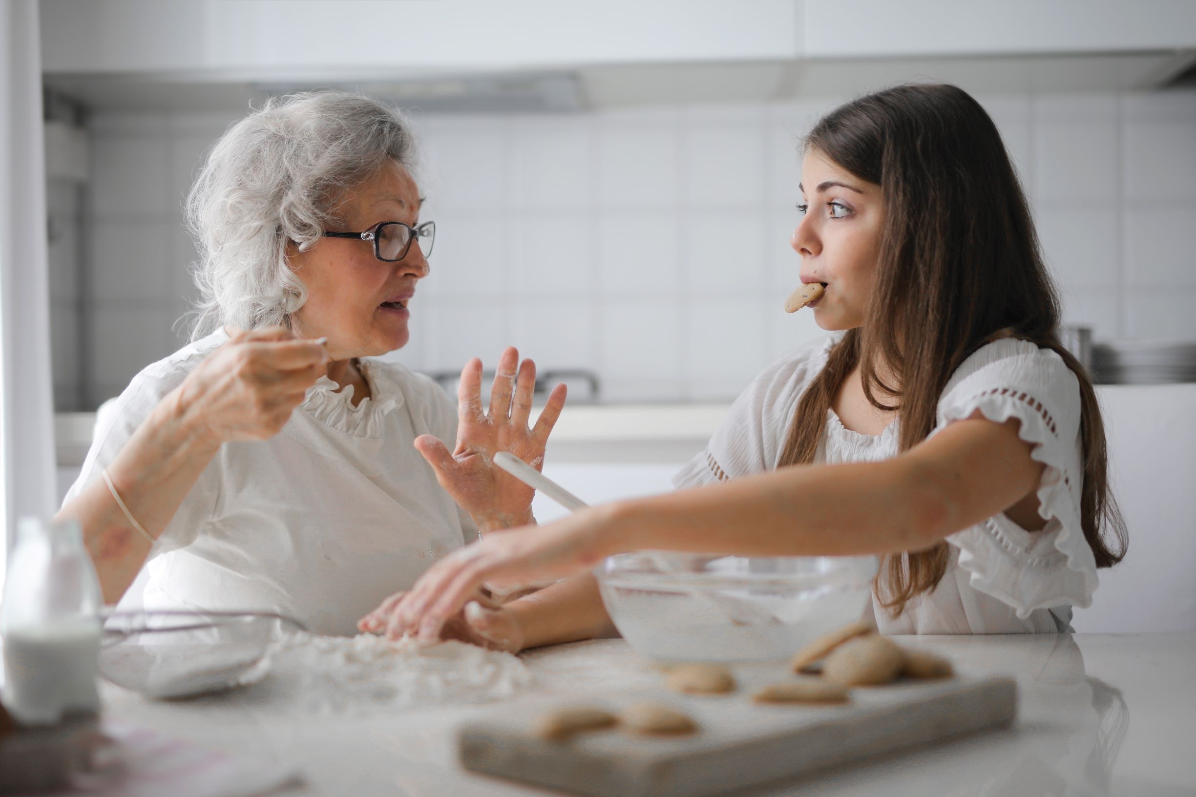 granddaughter and grandmother baking cookies